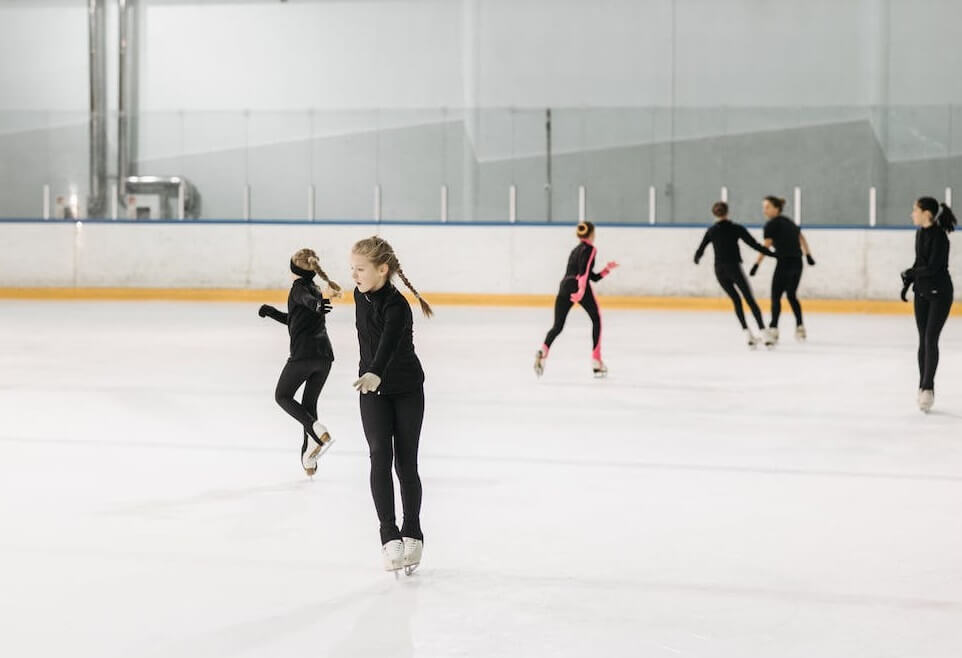 A busy ice rink showing how many figure skaters are practicing at once.