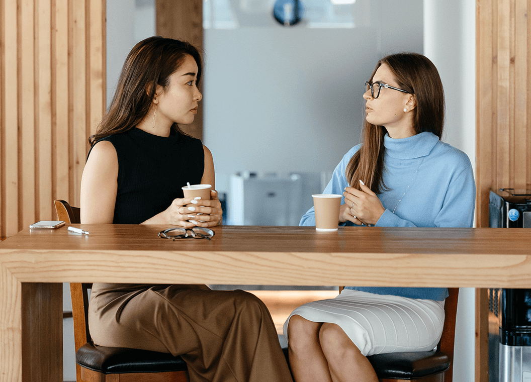 Mentor and mentee talking over a cup of coffee