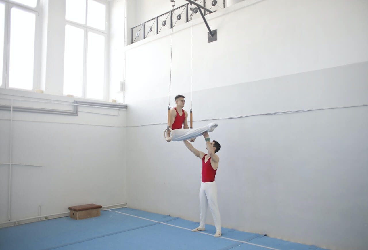 Two gymnasts using rings.