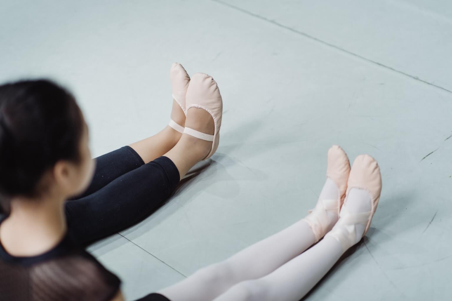 Dancer stretching with her instructor