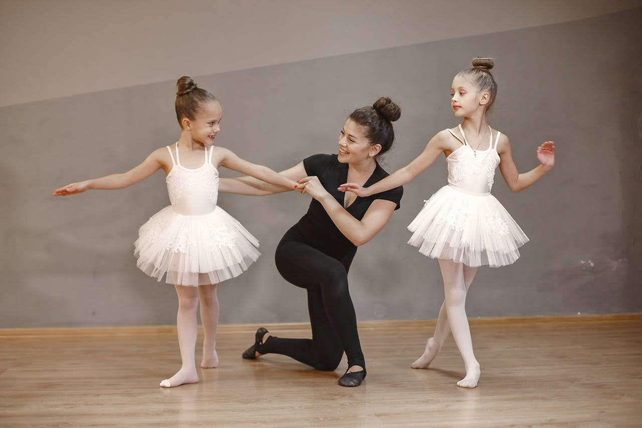 Dance instructor smiling with her dance students