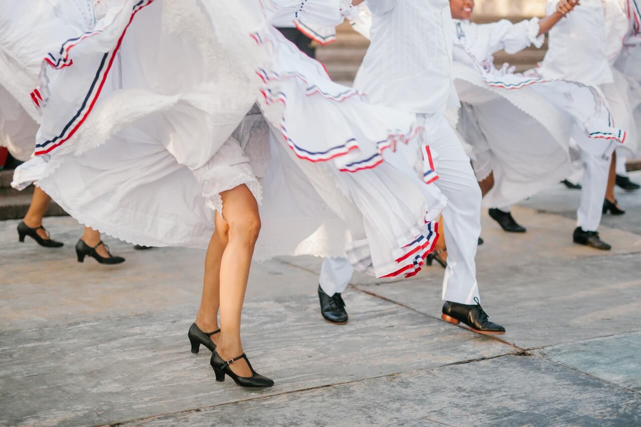 Dancers wearing white outfits. 