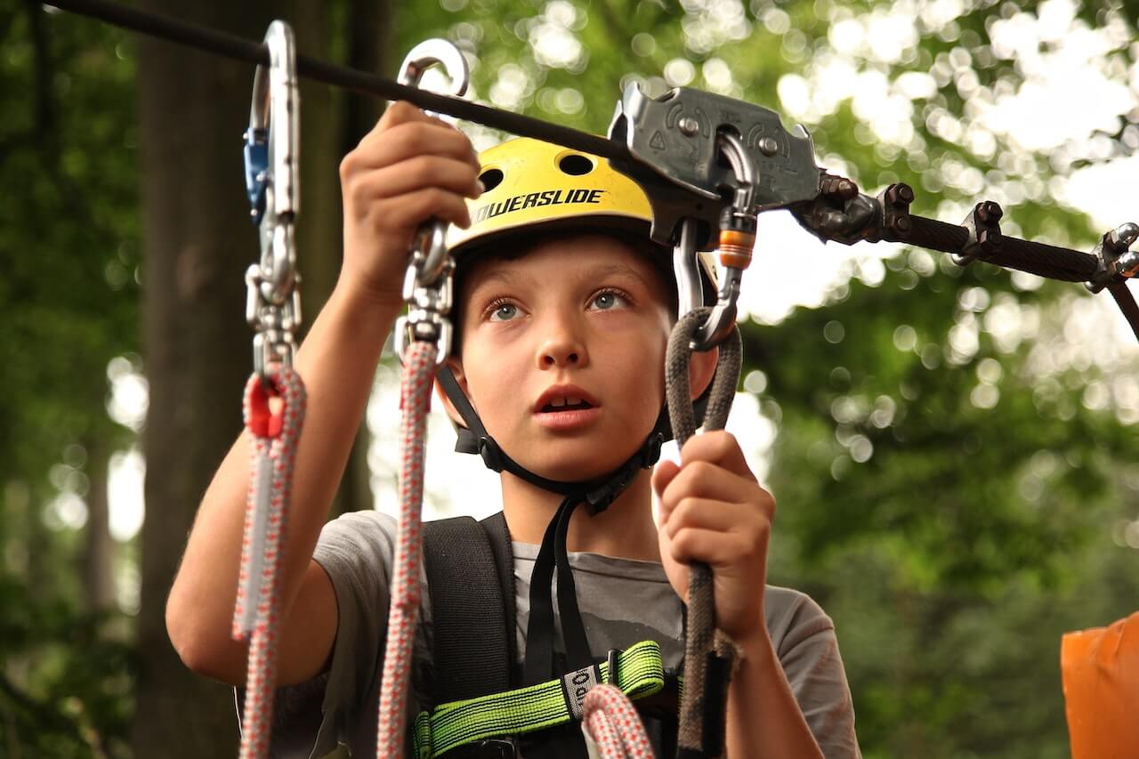 Camper trying new ropes course as part of a camper retention strategy.