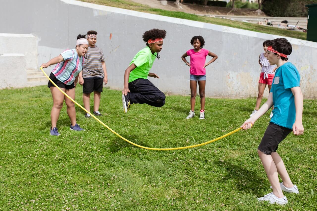 Kids jumping rope at a camp.