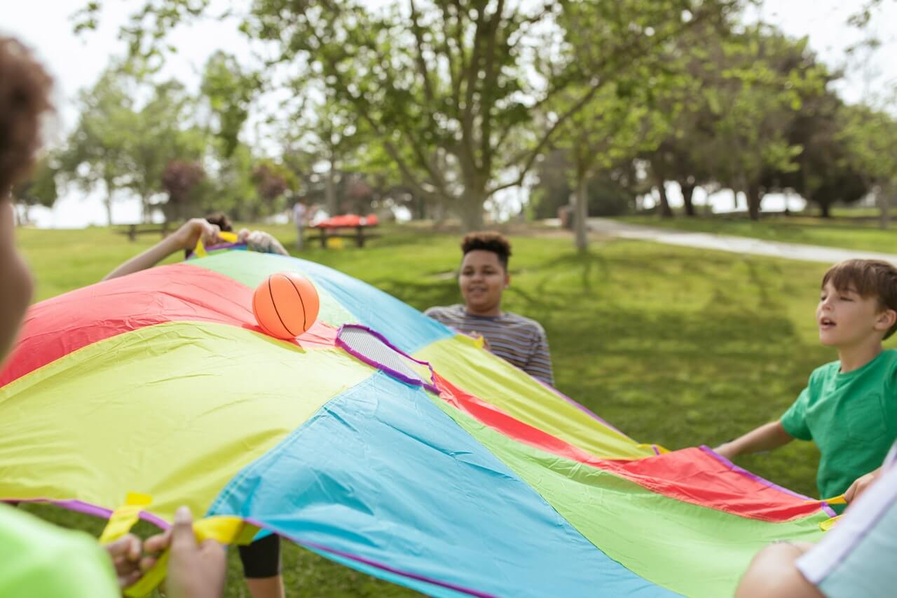 Kids playing parachute games at summer camp
