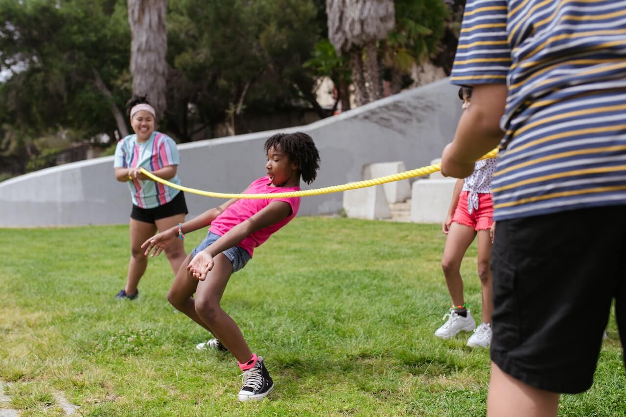 A girl playing limbo at summer camp