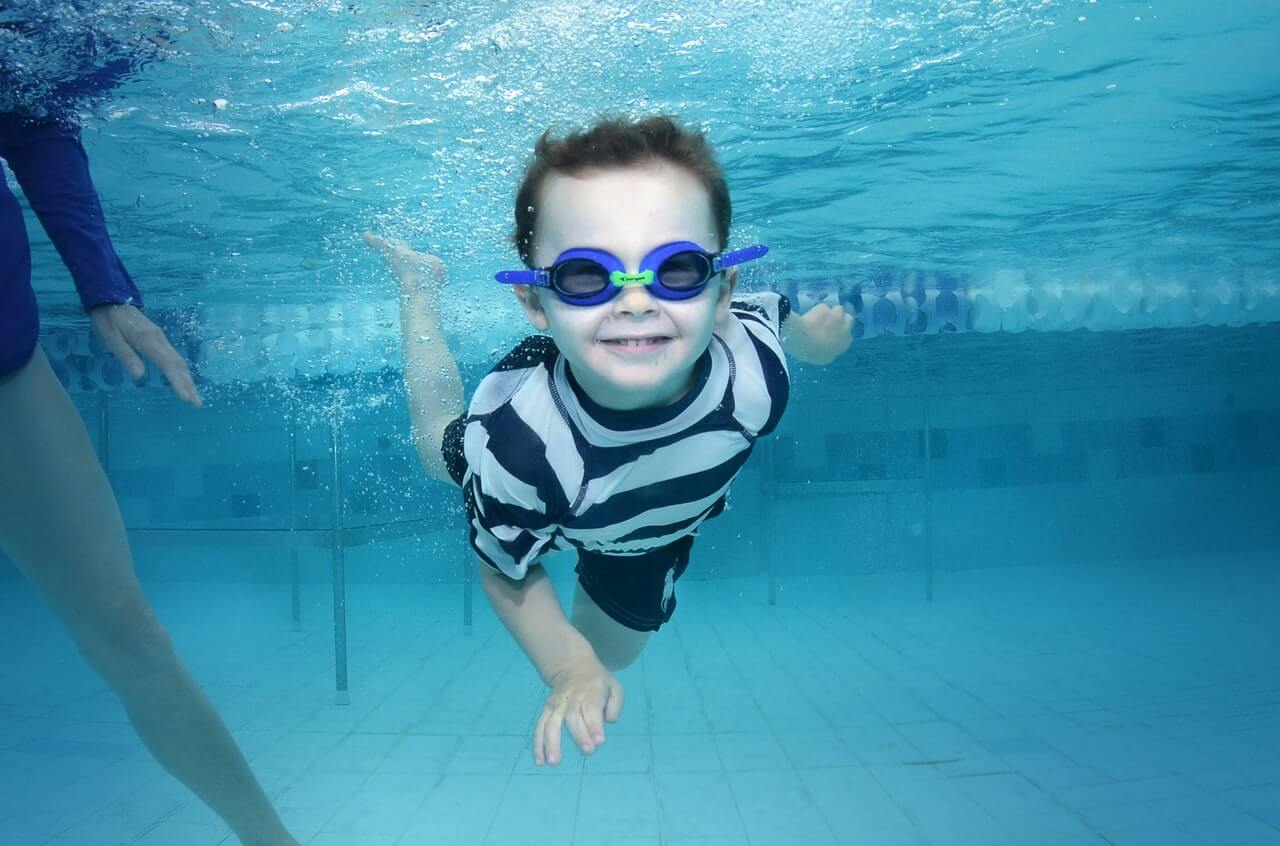 Child enjoying the benefits of swimming at a local pool
