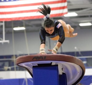 Gymnast quotes about training represented by a gymnast training on the vault