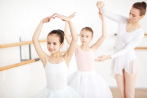 Ballet dancers with their instructor at the dance studio