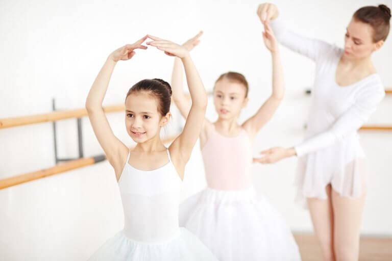 Ballet dancers with their instructor at the dance studio