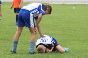 Injured soccer player is attended to as part of concussion safety protocols.