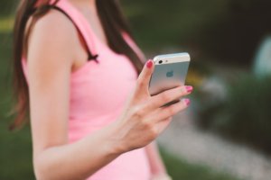 Fitness teacher using a mobile phone for virtual athlete training