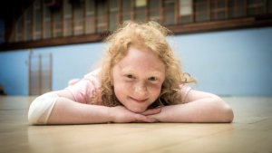 Gymnast smiling on gym floor