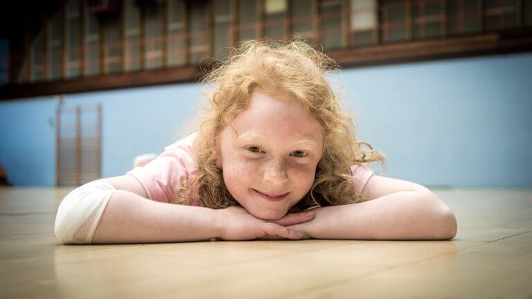 Gymnast smiling on gym floor