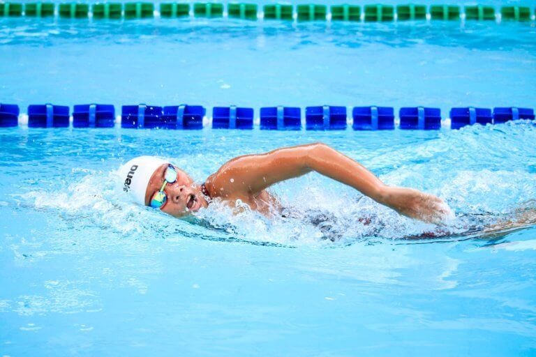 A swimmer in the pool enjoying the benefits of swimming