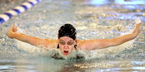 Exhausted swimmer training in pool