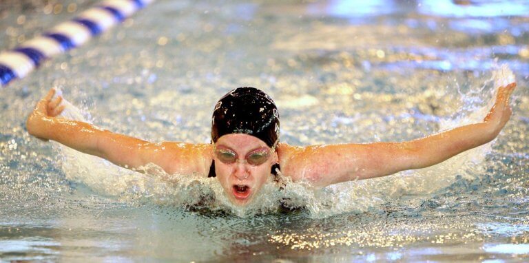 Exhausted swimmer training in pool