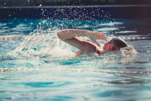 Active kids swimming in pool